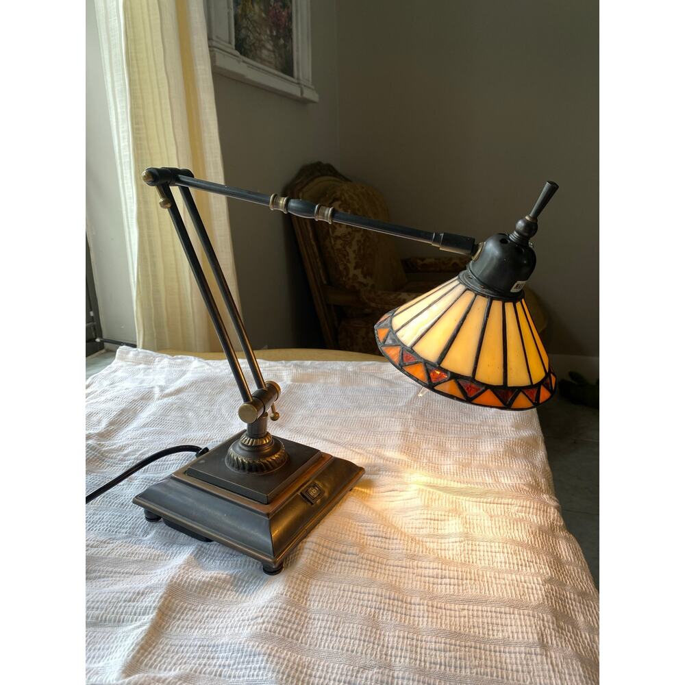Quoizel adjustable swing arm table lamp with a Tiffany-style stained glass shade